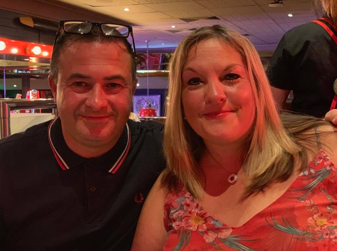 Two people smiling at the camera